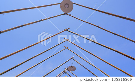 Low Angle View of Bamboo Frame and Outdoor Lamps 135816509