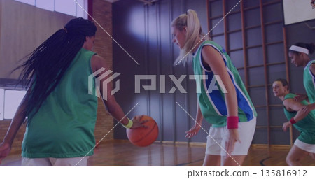 Dribbling Black athlete driving toward defender on gym court with green jerseys and bars copy space 135816912