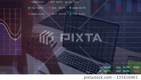 Analyzing woman in fitted top reviewing data overlays in office, with laptop, notebook, pen Analyzing woman in fitted top reviewing data overlays in office, with laptop, notebook, pen 135816961