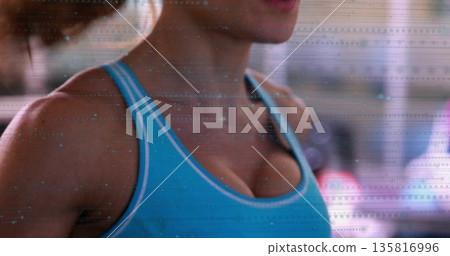 Showing woman exercising in gym wearing blue tank top black sports bra strap under glitch overlay Showing woman exercising in gym wearing blue tank top black sports bra strap under glitch overlay 135816996