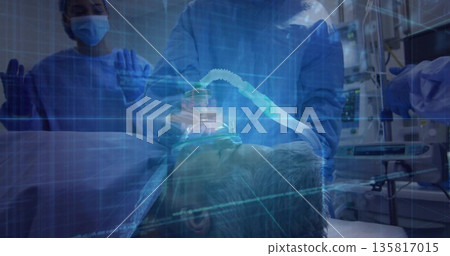 Staff in gowns adjusting oxygen mask and tube on patient in ER, grid overlay and monitors 135817015