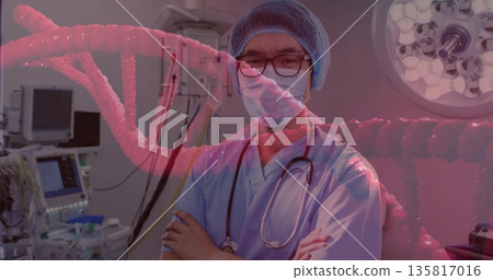 Standing surgeon wearing scrubs and stethoscope, crossing arms in operating room, with DNA overlay 135817016