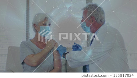 Injecting doctor with gloves giving vaccine to patient on sofa in clinic room, featuring syringe Injecting doctor with gloves giving vaccine to patient on sofa in clinic room, featuring syringe 135817024