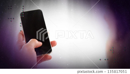 Gripping human hand holding smartphone in studio gradient backdrop, with glitch overlay, copy space 135817051