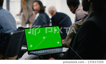 Mockup display on laptop at panel with public speaker during international conference summit. Diverse professional participants group attend convention focused on startup development. 135817209