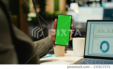 Isolated mockup vertical screen on phone where black office employee finishing tasks after hours, late night work session. Researching documents and ensure alignment with company targets. Camera B. Isolated mockup vertical screen on phone where black office employee finishing tasks after hours, late night work session. Researching documents and ensure alignment with company targets. Camera B. 135817272