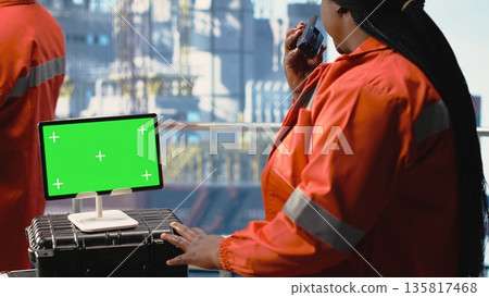 Isolated screen tablet used by offshore platform worker supervising production activity on oil rig deck. Drilling rig employee doing maintenance with chroma key device device Isolated screen tablet used by offshore platform worker supervising production activity on oil rig deck. Drilling rig employee doing maintenance with chroma key device device 135817468