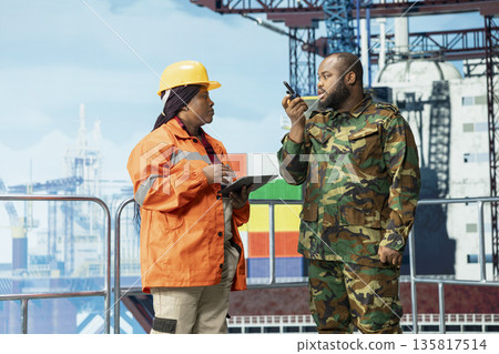 Armed forces soldier maintaining presence on offshore rig to deter insurgent criminal attacks. Naval unit performs boarding on drilling barge under maritime interdiction protocol 135817514