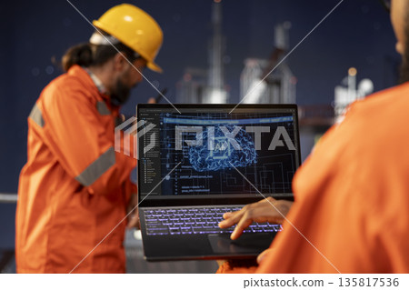 Close up of offshore platform technician using predictive AI models to forecast equipment maintenance needs. Specialist analyzing machine learning data on dashboard to prevent mechanical failures 135817536