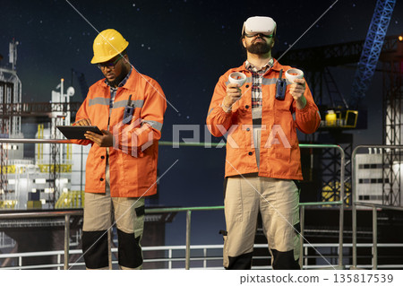 Drilling rig expert performing immersive seabed analysis using virtual reality goggles. Offshore platform technician visualizing underwater topography through VR gear for precision drilling Drilling rig expert performing immersive seabed analysis using virtual reality goggles. Offshore platform technician visualizing underwater topography through VR gear for precision drilling 135817539