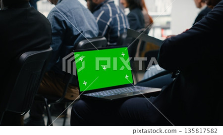 Mockup on laptop screen during corporate summit with panel discussion and public speaker. Audience of colleagues participants attend convention for leadership training and development. 135817582