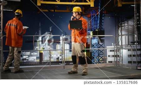 Engineer on offshore drilling platform exchange insights on walkie talkie, coordinating fuel and natural petroleum extraction on oil rig. Efficient fossil fuels production. 135817686