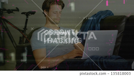 Typing man in modern living room, with laptop, bike, denim jacket and growth hacking overlay 135818003