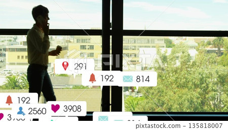 Walking office worker holding phone and coffee cup in office with notifications, copy space 135818007