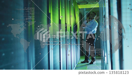 Handling smartphone, male technician in business shirt monitoring data in server racks, copy space 135818123