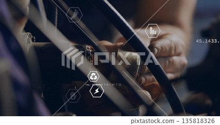 Operating technician hands connecting connector to cable bundles in workshop, with digital overlays 135818326