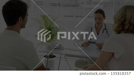 Reviewing medical document white coat physician consulting couple at exam room, with corded phone Reviewing medical document white coat physician consulting couple at exam room, with corded phone 135818357