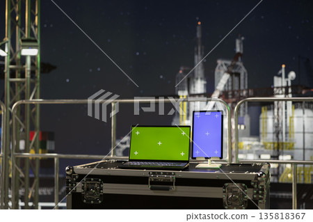 Green screen mockup devices on offshore platform used for tracking carbon footprint. Isolated screen chroma key laptop and tablet on drilling ship used for ensuring sustainable practices 135818367