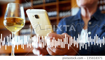 Holding senior woman viewing smartphone at cozy wine cellar, with wine glass and wooden shelves Holding senior woman viewing smartphone at cozy wine cellar, with wine glass and wooden shelves 135818371