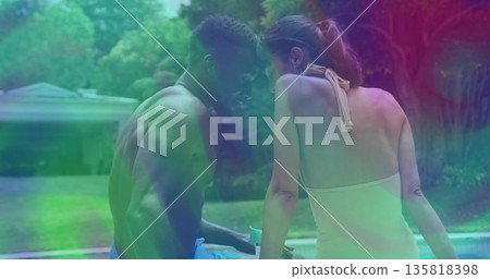 Chatting man in swim trunks and woman in halter swimsuit at suburban backyard pool, with smartphone Chatting man in swim trunks and woman in halter swimsuit at suburban backyard pool, with smartphone 135818398