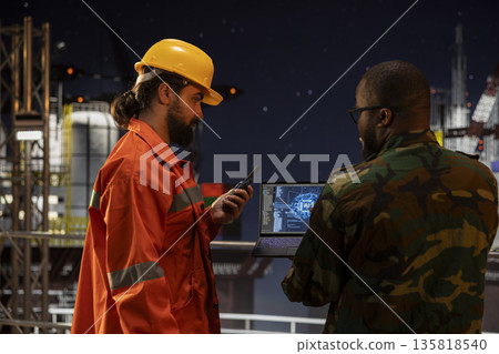Soldier protecting national energy assets on drilling ship using AI machine learning tech. Military unit on offshore platform detecting enemies using artificial intelligence neural network technology Soldier protecting national energy assets on drilling ship using AI machine learning tech. Military unit on offshore platform detecting enemies using artificial intelligence neural network technology 135818540