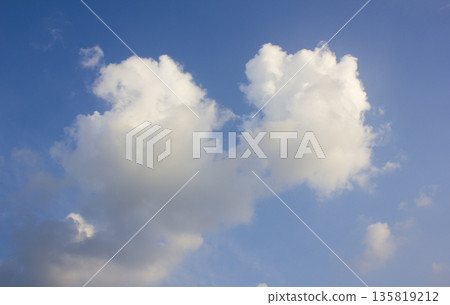 It's a blue sky with atmospheric puffy clouds. It's a blue sky with atmospheric puffy clouds. 135819212