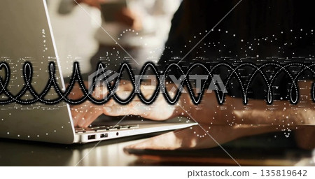 Typing mid adult Asian woman wearing long-sleeve top in office, with laptop tablet waveform overlay 135819642