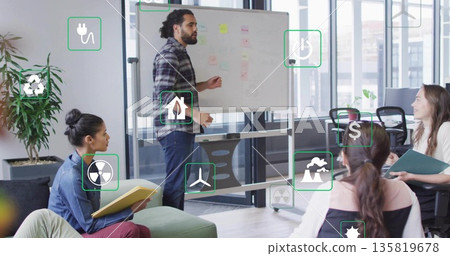 Presenting man pointing at whiteboard in meeting room, with floating energy icons and sticky notes Presenting man pointing at whiteboard in meeting room, with floating energy icons and sticky notes 135819678