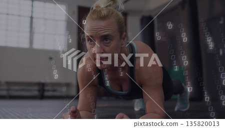 Holding plank position woman in athletic wear on mat at gym with binary code overlay Holding plank position woman in athletic wear on mat at gym with binary code overlay 135820013