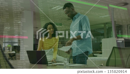Collaborating woman and male colleague reviewing documents in office, with laptop printed sheets Collaborating woman and male colleague reviewing documents in office, with laptop printed sheets 135820914