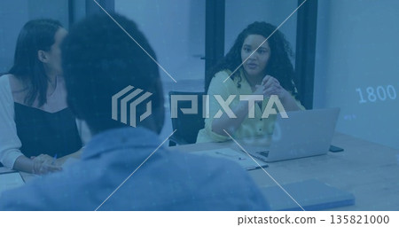 Woman wearing yellow blouse hosting meeting at conference table, using laptop, copy space 135821000