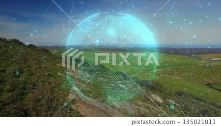 Displaying digital holographic globe floating above hillside, near rocky footpath toward farm plots Displaying digital holographic globe floating above hillside, near rocky footpath toward farm plots 135821011
