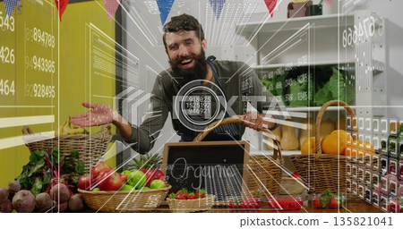 Displaying vendor wearing apron arranging baskets under bunting flags at stall, with organic sign 135821041