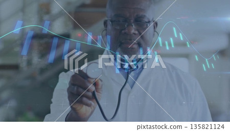 Displaying senior male doctor in white coat showing holographic charts in clinic, with stethoscope Displaying senior male doctor in white coat showing holographic charts in clinic, with stethoscope 135821124