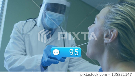 Performing throat swab doctor wearing face shield mask gloves in clinic, with notification bubble Performing throat swab doctor wearing face shield mask gloves in clinic, with notification bubble 135821147