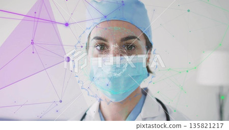 Standing doctor wearing scrub cap and mask in clinical office, with stethoscope and mesh overlay 135821217
