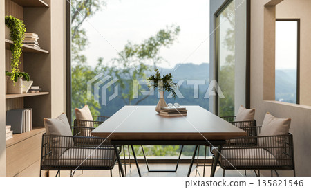 Vase and books on wooden table and metal armchairs in a room with window wall and mountain scenery. 135821546