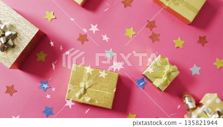 Gift boxes with ribbons over star confetti image on pink background 135821944