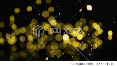Golden bokeh lights with star shapes image on black background Golden bokeh lights with star shapes image on black background 135821950