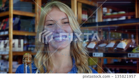 Denim-clad woman getting face scan using digital overlay in deli, with wine bottle, wooden shelves Denim-clad woman getting face scan using digital overlay in deli, with wine bottle, wooden shelves 135821957