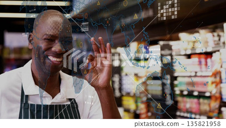 Clerk wearing striped apron gesturing OK among supermarket shelves with digital overlay, copy space Clerk wearing striped apron gesturing OK among supermarket shelves with digital overlay, copy space 135821958