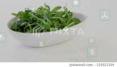 Showcasing white ceramic bowl of green arugula leaves on tabletop, with floating green energy icons Showcasing white ceramic bowl of green arugula leaves on tabletop, with floating green energy icons 135822104
