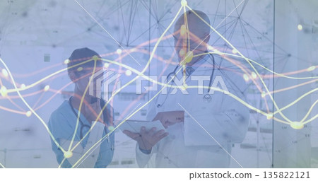 Medics reviewing patient data on tablet in glass corridor with stethoscopes and overlay Medics reviewing patient data on tablet in glass corridor with stethoscopes and overlay 135822121