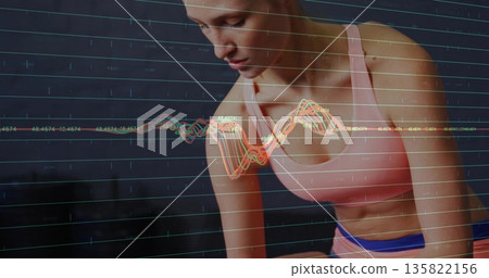 Monitoring athlete wearing pink sports bra, leggings in studio showing grid and waveform overlay 135822156