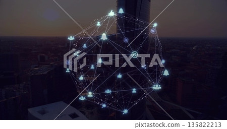 Hovering 3D network sphere glowing above cylindrical skyscraper at dusk, with social media icons Hovering 3D network sphere glowing above cylindrical skyscraper at dusk, with social media icons 135822213