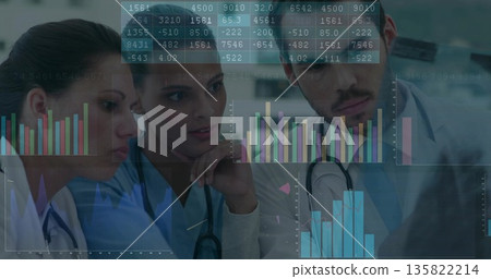Medical team wearing scrubs and stethoscopes interpreting digital charts in clinical workspace 135822214