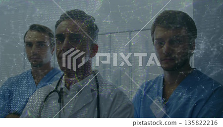 Standing staff wearing white coat and stethoscope, blue scrubs and ID badges in ward, data overlay Standing staff wearing white coat and stethoscope, blue scrubs and ID badges in ward, data overlay 135822216