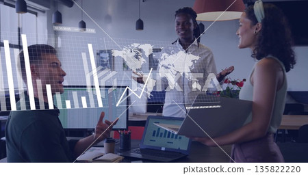 Professional team collaborating in office reviewing holographic map charts with laptop and monitors Professional team collaborating in office reviewing holographic map charts with laptop and monitors 135822220