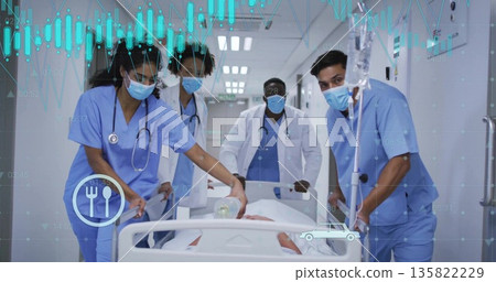 Moving medical team in blue scrubs guiding patient on gurney down hospital corridor, with Ambu bag Moving medical team in blue scrubs guiding patient on gurney down hospital corridor, with Ambu bag 135822229