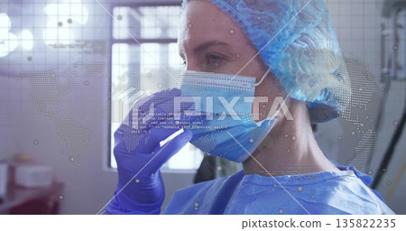 Gloved nurse adjusting surgical mask in clinic room, with digital overlays, copy space 135822235